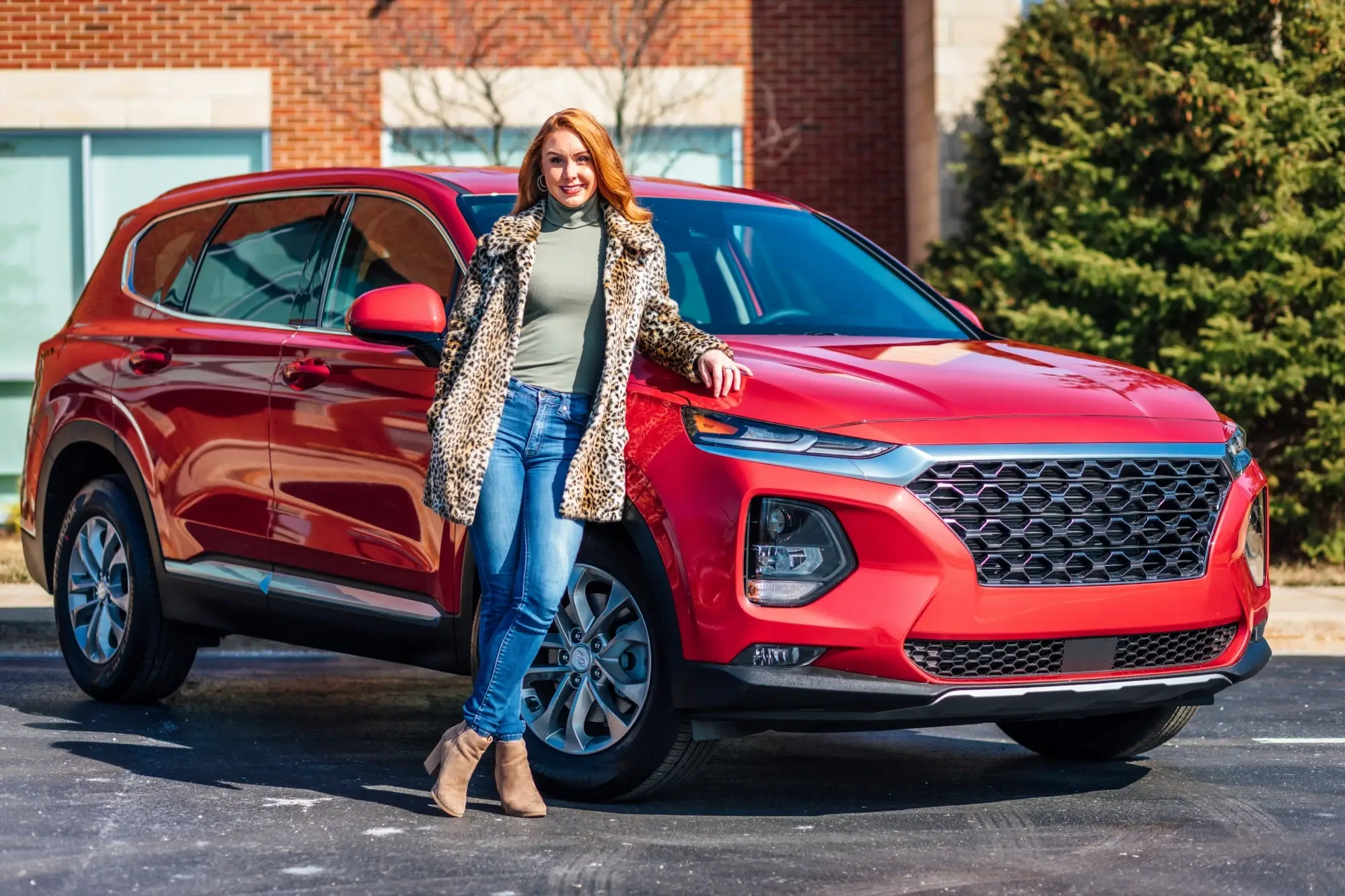 Woman with red SUV